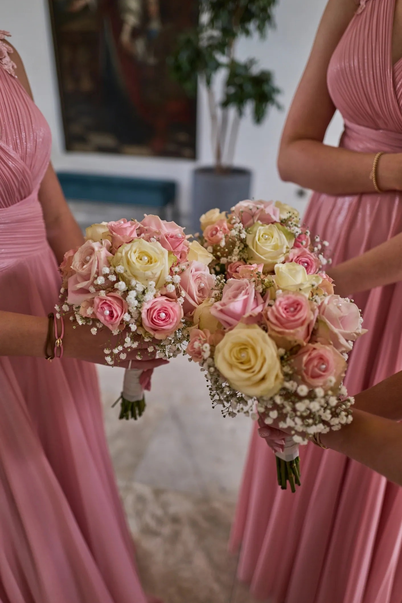 Bridesmaids holding elegant pastel wedding bouquets