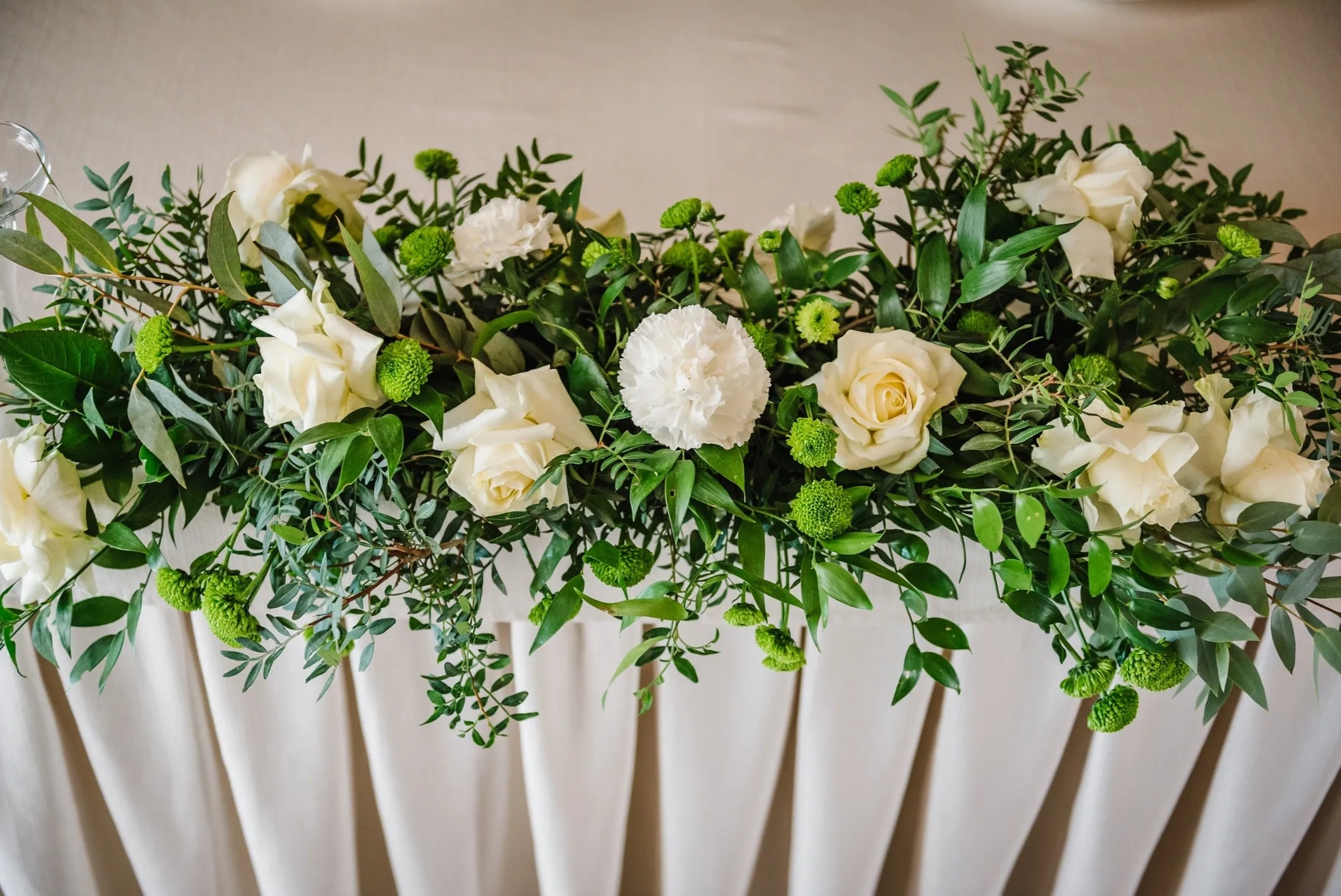 Wedding top table decorated with a beautiful floral garland